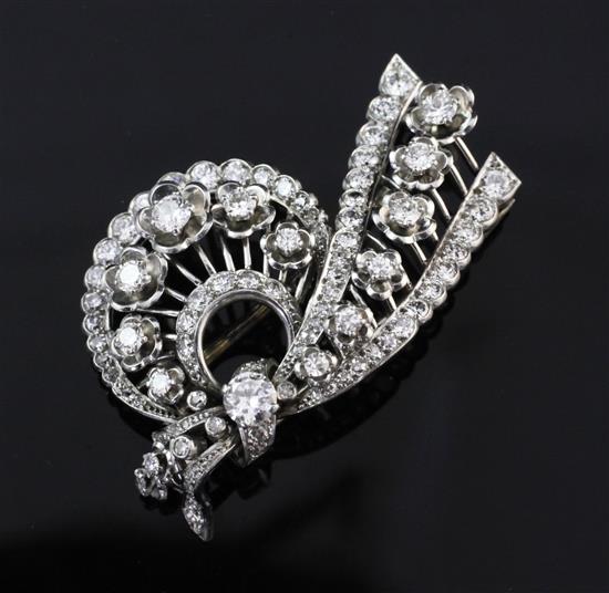 A 1950s Cartier platinum and diamond clip brooch, approx. 2in.